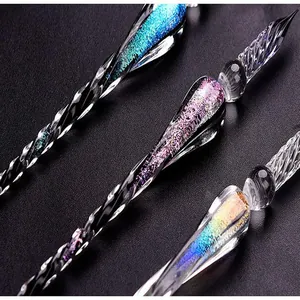 Macro view of handmade starry glass dip pens with glitter foil accents