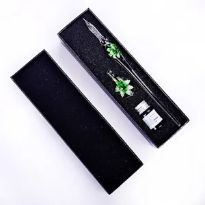 Detailed view of handmade green floral inlay glass dip pen set with ink in gift box