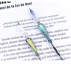 Close-up detail of two handmade starry sky glass dip pens with shimmering glitter interior