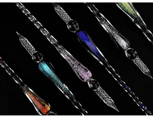 Detailed macro view of handmade starry sky glass dip pens with vibrant colorful glitter