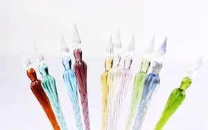 A collection of colorful handmade glass dip pens featuring elegant spiral designs