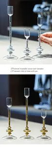 Elegant glass candle holders with silver and gold glitter stems in varied heights.