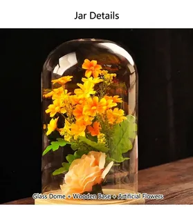Decorative glass display dome cloche with wooden base and artificial yellow flowers
