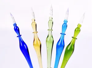 Detailed view of colorful glass dip pens with spiral nibs and translucent texture