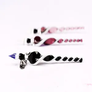 Macro view of a handcrafted glass dip pen with a twisted black and white spiral design