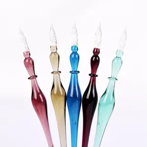 Detailed view of five colorful glass dip pens with spiral nibs for creative calligraphy