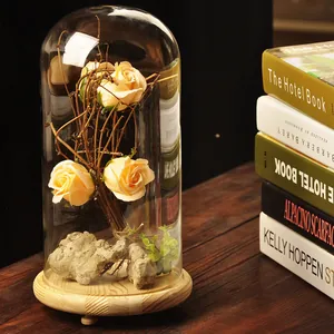 Elegant glass dome display with artificial yellow roses and wooden base for home decor