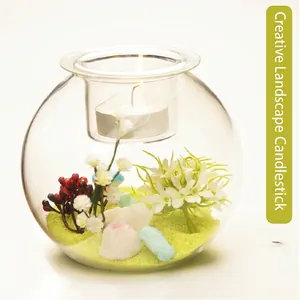 Elegant creative clear glass candle holder featuring a miniature floral landscape interior