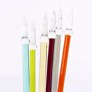 Set of colorful handmade glass dip pens with spiral nibs shown on white background