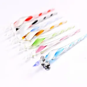 Detailed macro view of colorful spiral glass dip pens showing intricate handmade textures