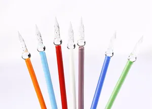Detailed close-up view showing clear twisted glass nibs on colorful handmade dip pens