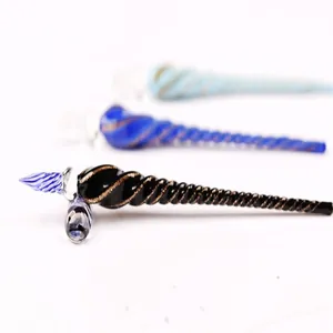 Detailed view of handmade glass dip pens with elegant spiral patterns in various colors