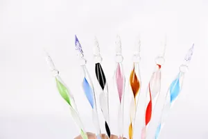 Macro view of handmade colorful glass dip pens with elegant spiral nibs for artistic calligraphy