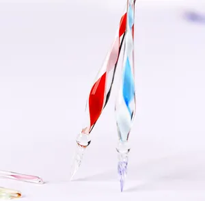 Macro detail of exquisite handmade glass dip pen nibs featuring colorful spiral designs