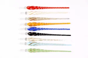Professional collection of colorful spiral glass dip pens for calligraphy and ink testing.