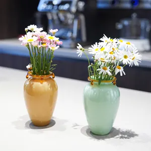 Elegant pair of designer glass vases with daisy flowers for home and cafe table decoration