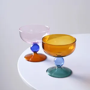 Two heat-resistant colorful glass dessert cups with spherical stems for ice cream