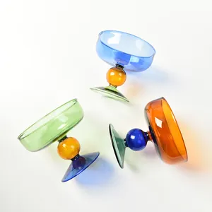 Set of three colorful heat-resistant glass dessert bowls with decorative ball stems