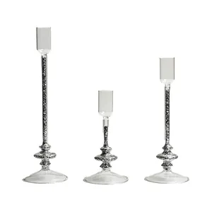 Set of three elegant tall glass candle holders with silver glitter stems for home decor