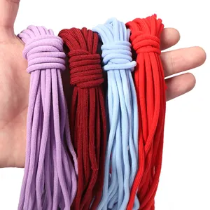 Close-up detail of colorful elastic drawstring cords bundles in purple, red, and blue.