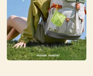 Close-up of portable green raincoat pouch attached to a beige backpack outdoors