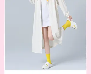 Detailed view of a stylish white long EVA raincoat with button closure and elastic cuffs.