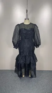 Detailed view of plus size black flocked polka dot dress with elegant puff sleeves