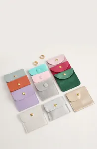 Detailed view of colorful microfiber velvet jewelry pouches with gold snap closures
