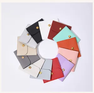 Premium selection of colorful faux leather jewelry snap pouches in a circular display layout.