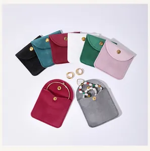 Multiple colors of velvet jewelry pouches with snap buttons for rings and bracelets
