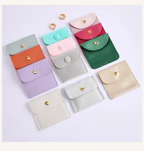 Variety of colorful jewelry snap pouches made from soft velvet and premium PU leather
