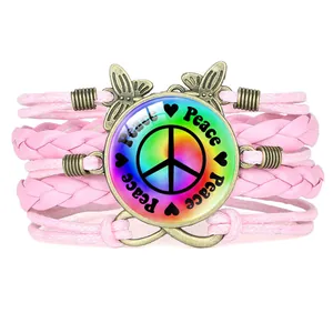 Pink multi-layer woven bracelet with colorful peace sign, butterfly and infinity charms.
