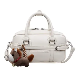 White PU leather boston handbag detail, stylish crossbody bag with cute horse pendant.