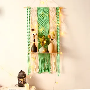 Bohemian handmade woven wall hanging tapestry with wooden shelf, green and beige cotton decor.