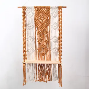 Detailed view of handmade bohemian woven tapestry shelf, cotton rope and wood texture.