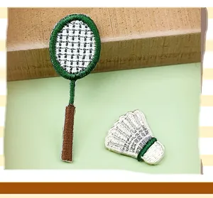 Embroidered badminton racket and shuttlecock patch DIY clothing accessory for sports lovers.
