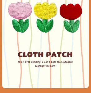 Tulip flower embroidered cloth patch detail showing colorful stitched petals and green leaves.