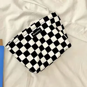 Black and white checkerboard cosmetic bag, retro portable makeup pouch for daily use.