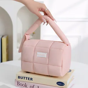 Detailed view of the pink quilted puffer cosmetic bag, soft portable travel pouch design.