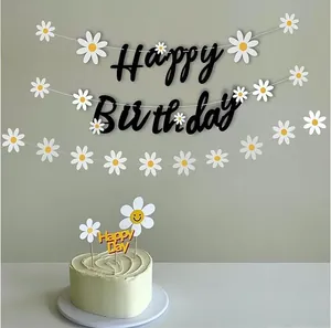 Daisy garland party decoration set with happy birthday banner and cute cake topper details.