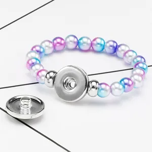 Close-up detail of gradient pearl beaded bracelet with silver interchangeable snap base