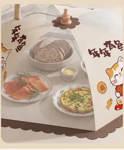 Close-up of a foldable square mesh food cover with a cute cat pattern over a dining table