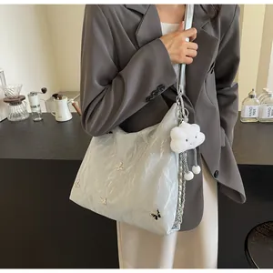 Stylish silver crinkled tote bag for women with cute butterfly charms and cloud pendant.