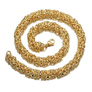 Detailed close-up of gold stainless steel Byzantine chain necklace with intricate link texture.