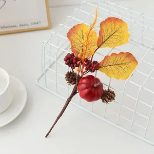 Artificial autumn maple leaf pumpkin branch for Halloween harvest festival holiday decor detail.