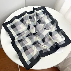 Detailed view of the black, white and purple geometric plaid cotton square scarf.