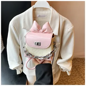Stylish pink mini bow lipstick crossbody bag with woven detail and silver chain