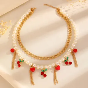 Detailed shot of double-layer necklace with faux pearls and red cherry charms