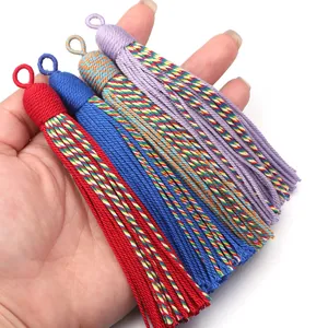 Close-up display of colorful handmade fabric tassels with loops, showing exquisite woven details.
