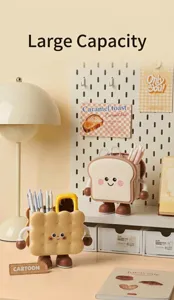 Cute cookie and toast-shaped pen holders and desk organizers on a tidy workspace